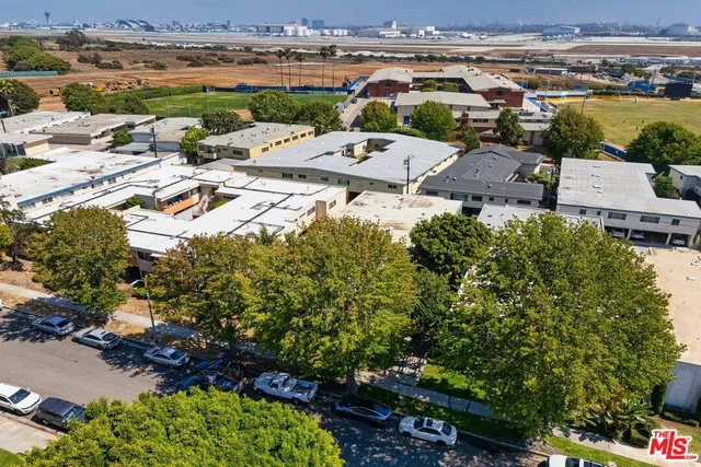 an aerial view of a house with a yard and lake view
