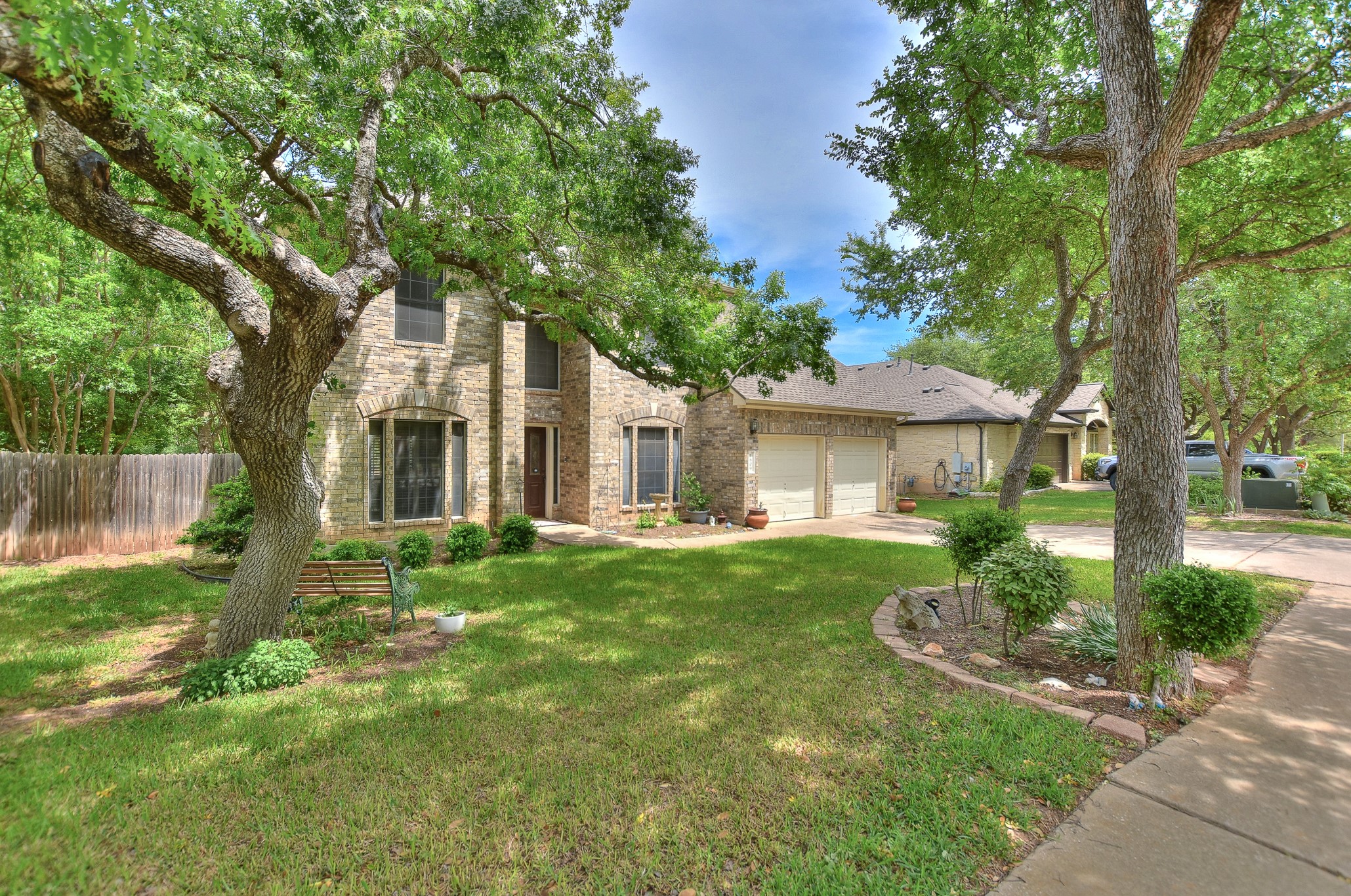 1609 Colton Way Cedar Park, TX 78613 - Photo 2 of 24 Mature trees shade this inviting brick residence, featuring an attached garage and well-maintained front lawn.