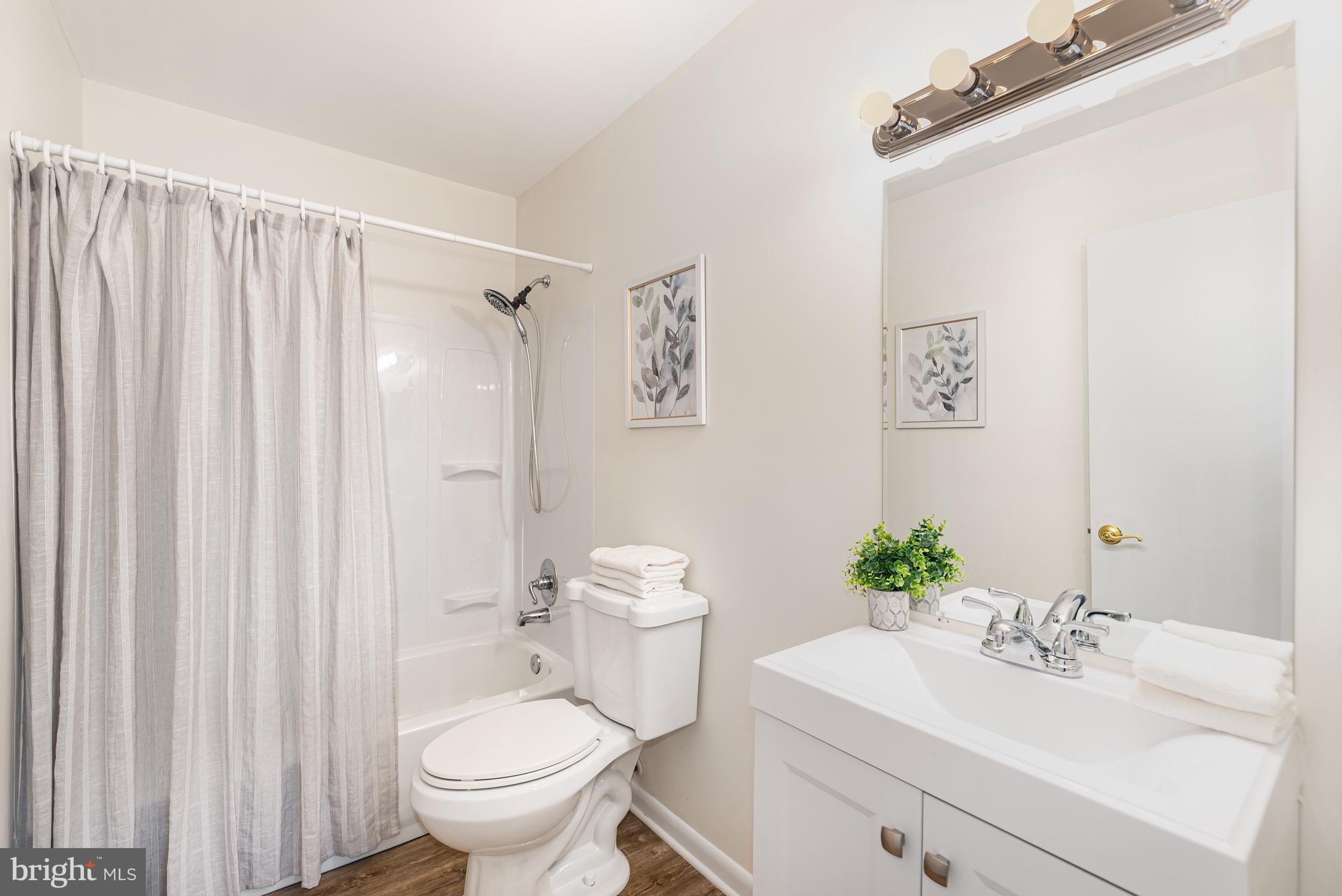 4219 Slater Avenue Nottingham, MD 21236 - Photo 16 of 25 a bathroom with a sink mirror and toilet