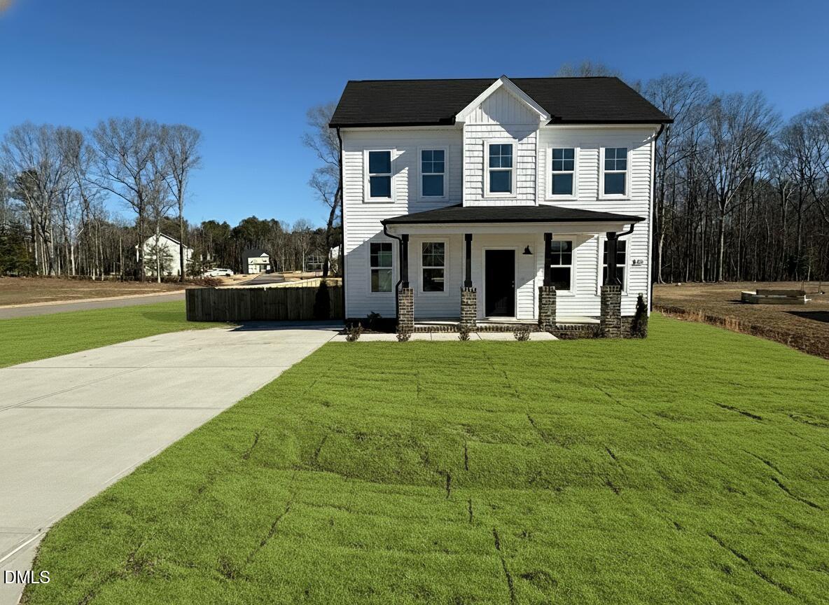 200 Longbow Drive Middlesex, NC 27557 - Photo 2 of 14 a front view of a house with garden and trees