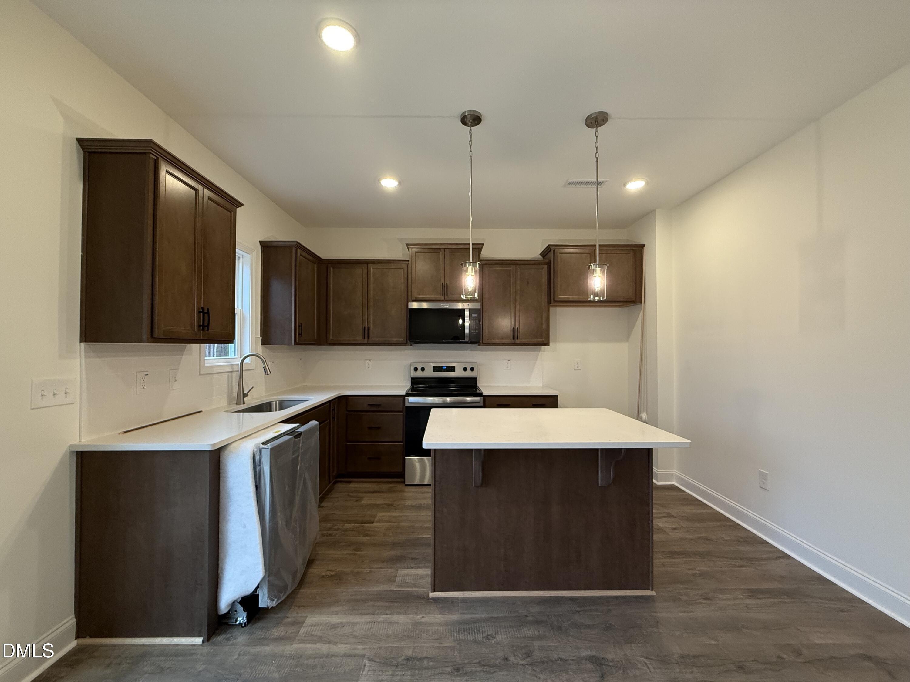 200 Longbow Drive Middlesex, NC 27557 - Photo 4 of 14 a large kitchen with stainless steel appliances a sink a stove and cabinets