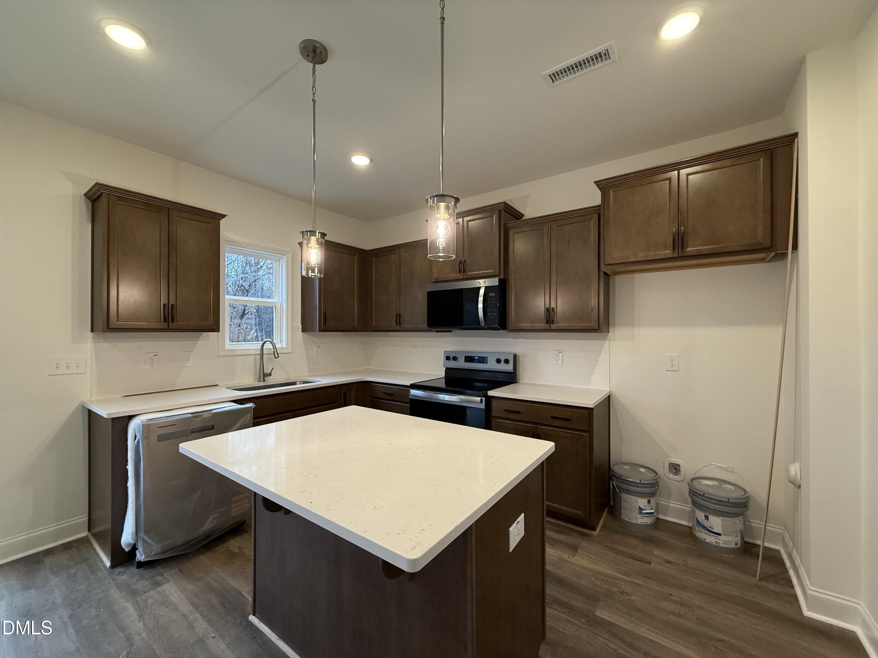 200 Longbow Drive Middlesex, NC 27557 - Photo 5 of 14 a kitchen with a stove a sink and a refrigerator
