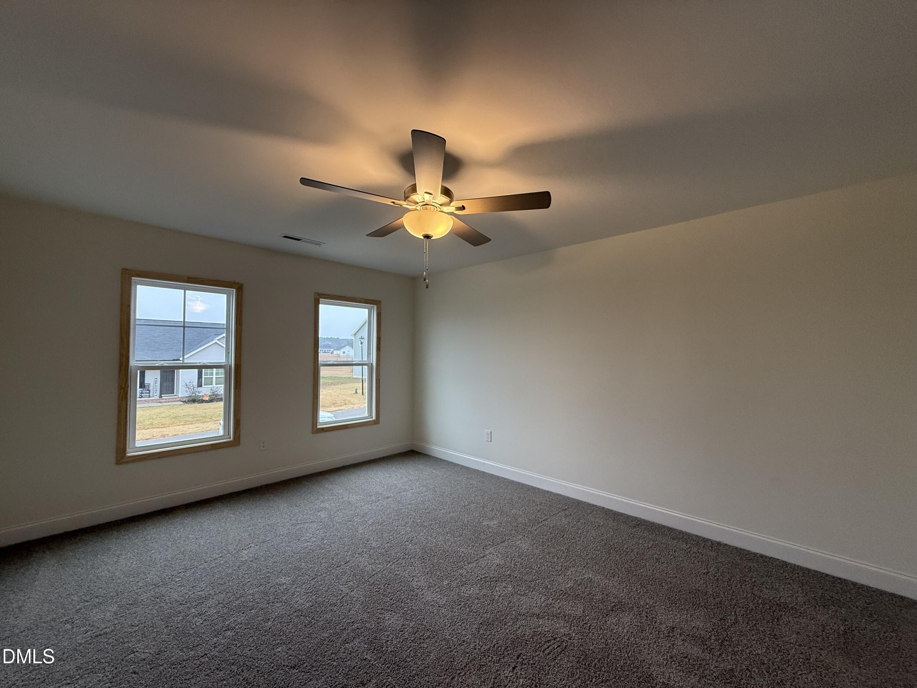 200 Longbow Drive Middlesex, NC 27557 - Photo 8 of 14 an empty room with windows and fan