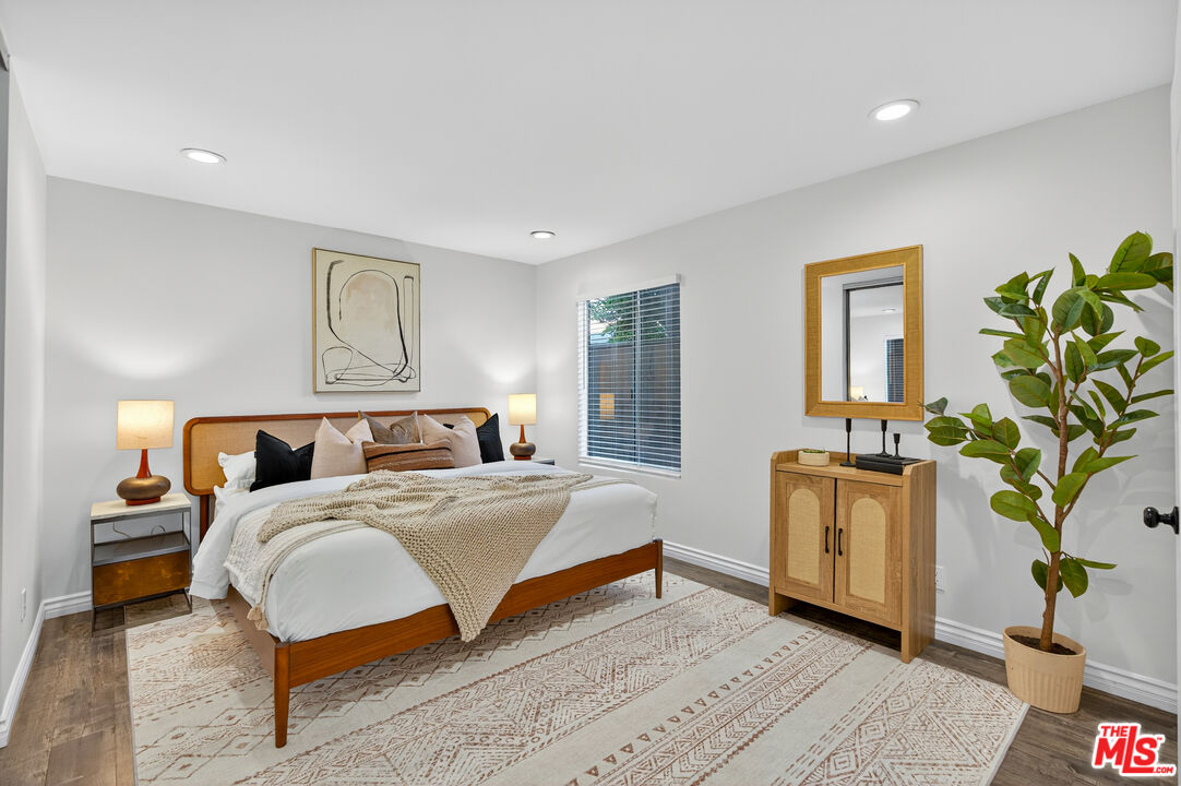 1125 Pico Boulevard, Unit 103 Santa Monica, CA 90405 - Photo 18 of 34 a bedroom with a bed and a potted plant