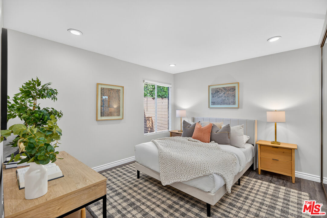 1125 Pico Boulevard, Unit 103 Santa Monica, CA 90405 - Photo 23 of 34 a bedroom with a bed and a potted plant