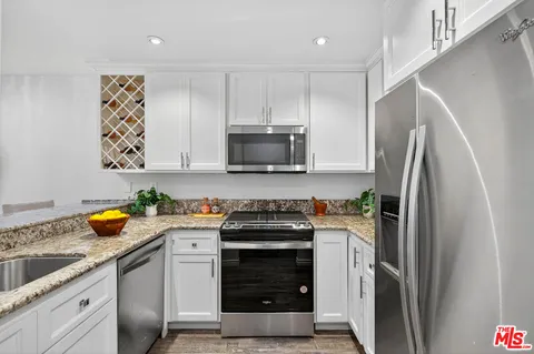 a kitchen with a stove and a refrigerator