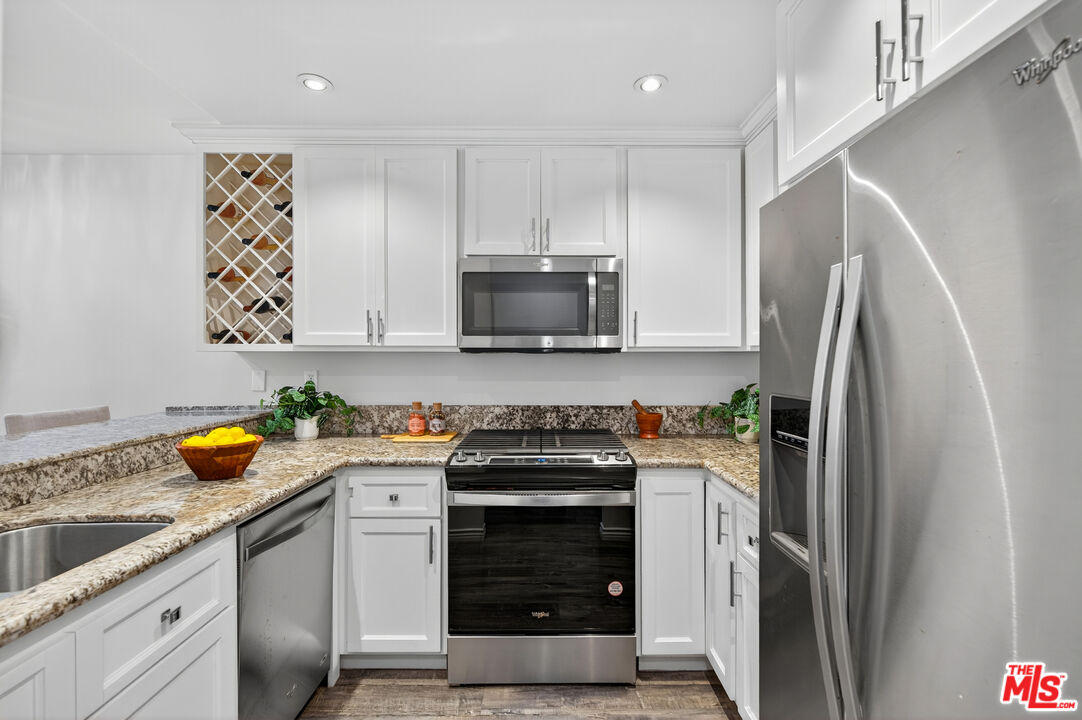 1125 Pico Boulevard, Unit 103 Santa Monica, CA 90405 - Photo 4 of 34 a kitchen with a stove and a refrigerator