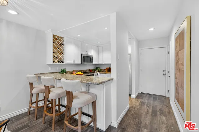 a view of kitchen with cabinets and wooden floor