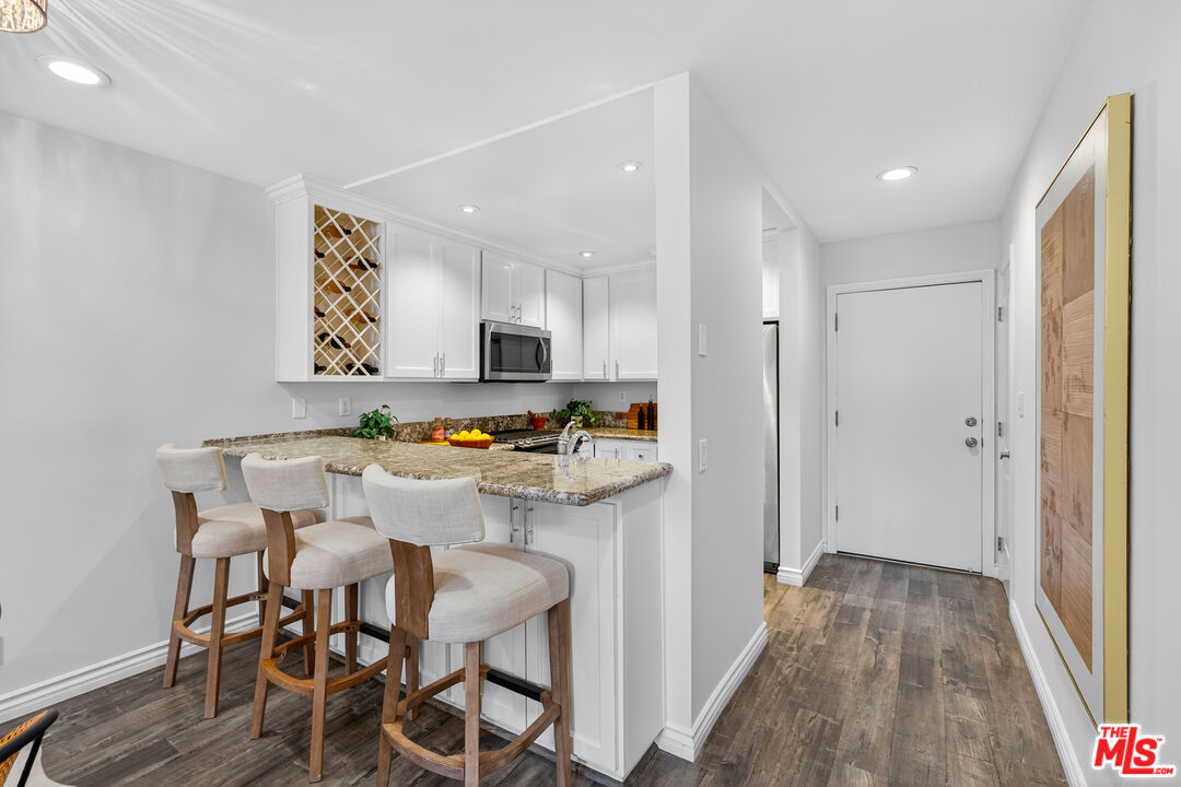 1125 Pico Boulevard, Unit 103 Santa Monica, CA 90405 - Photo 7 of 34 a view of kitchen with cabinets and wooden floor