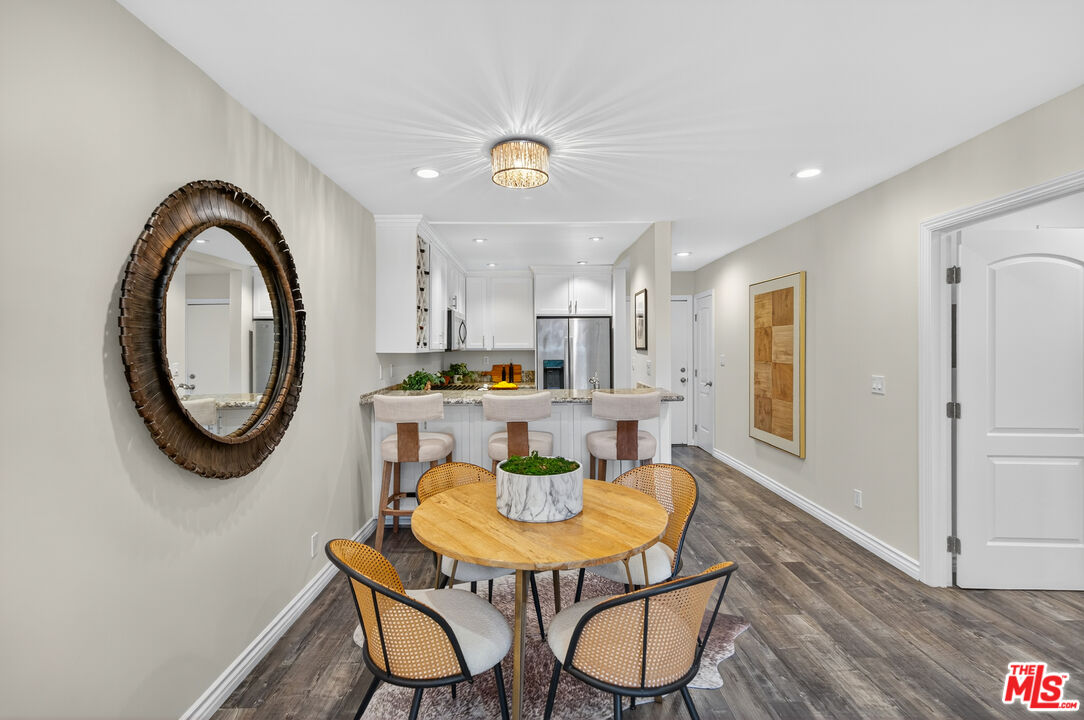 1125 Pico Boulevard, Unit 103 Santa Monica, CA 90405 - Photo 8 of 34 a view of a dining room with furniture and a chandelier