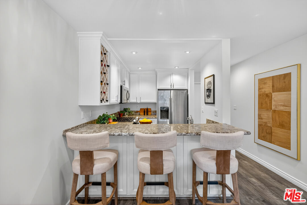 1125 Pico Boulevard, Unit 103 Santa Monica, CA 90405 - Photo 9 of 34 a view of a dining room with furniture and wooden floor
