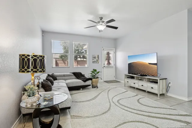 a kitchen with stainless steel appliances granite countertop a stove top oven a sink dishwasher a refrigerator and a refrigerator with wooden floor