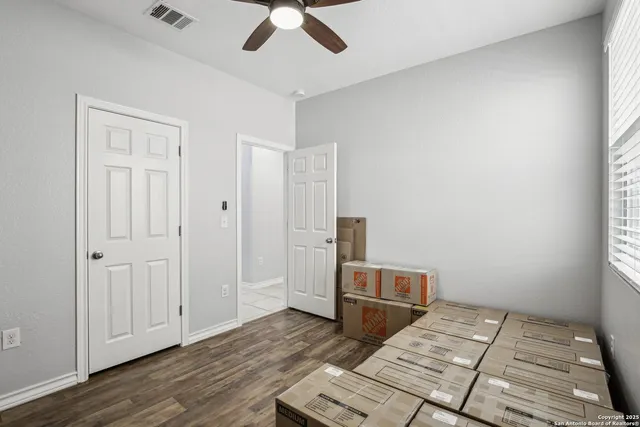 a bathroom with a granite countertop sink a toilet and a shower curtain