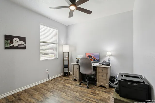 an empty room with wooden floor and mirror