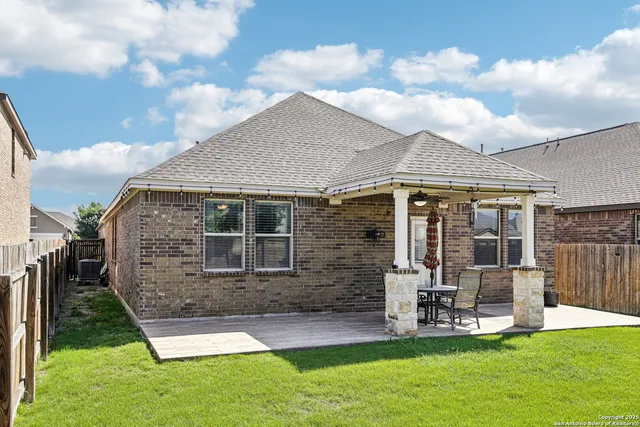 a view of a patio with table and chairs with wooden floor and fence