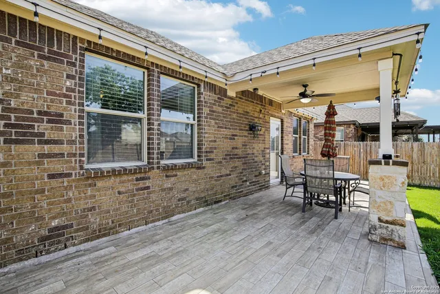 a balcony with table and chairs