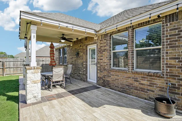 a view of a porch with furniture and a yard