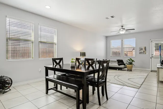 a view of a dining room with furniture and a window