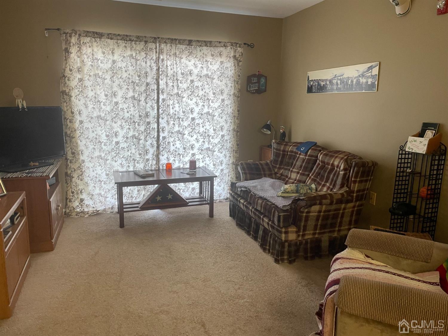 105 Liddle Avenue Edison, NJ 08837 - Photo 2 of 12 a bedroom with furniture and a flat screen tv