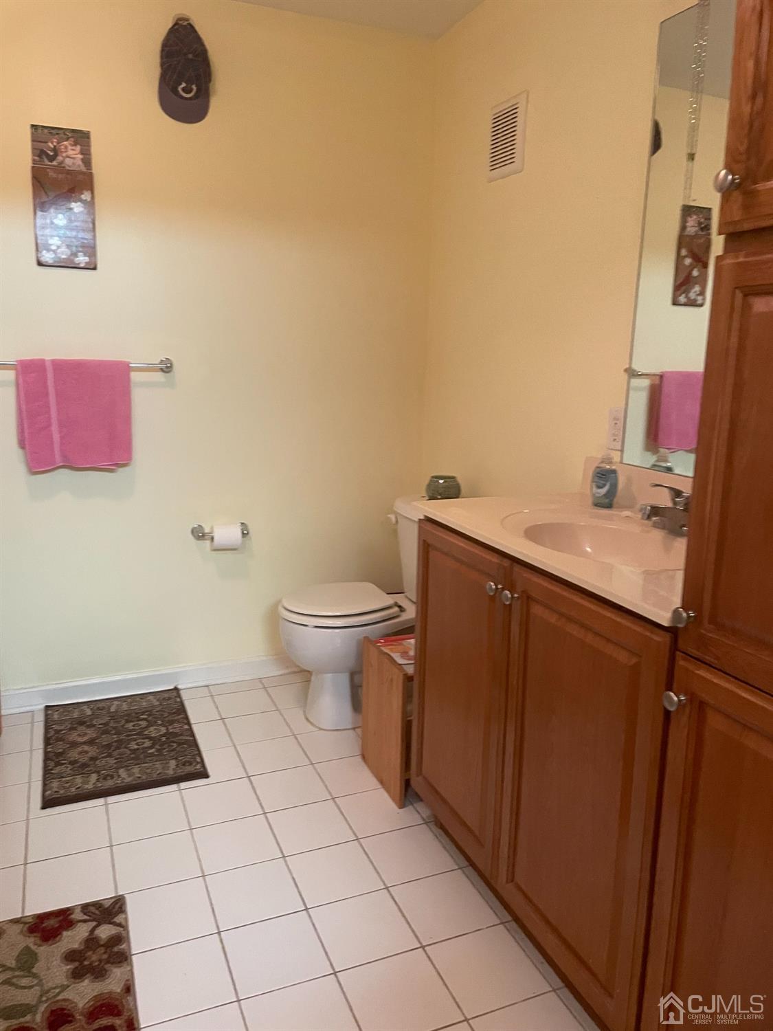 105 Liddle Avenue Edison, NJ 08837 - Photo 5 of 12 a bathroom with a sink a toilet and a mirror