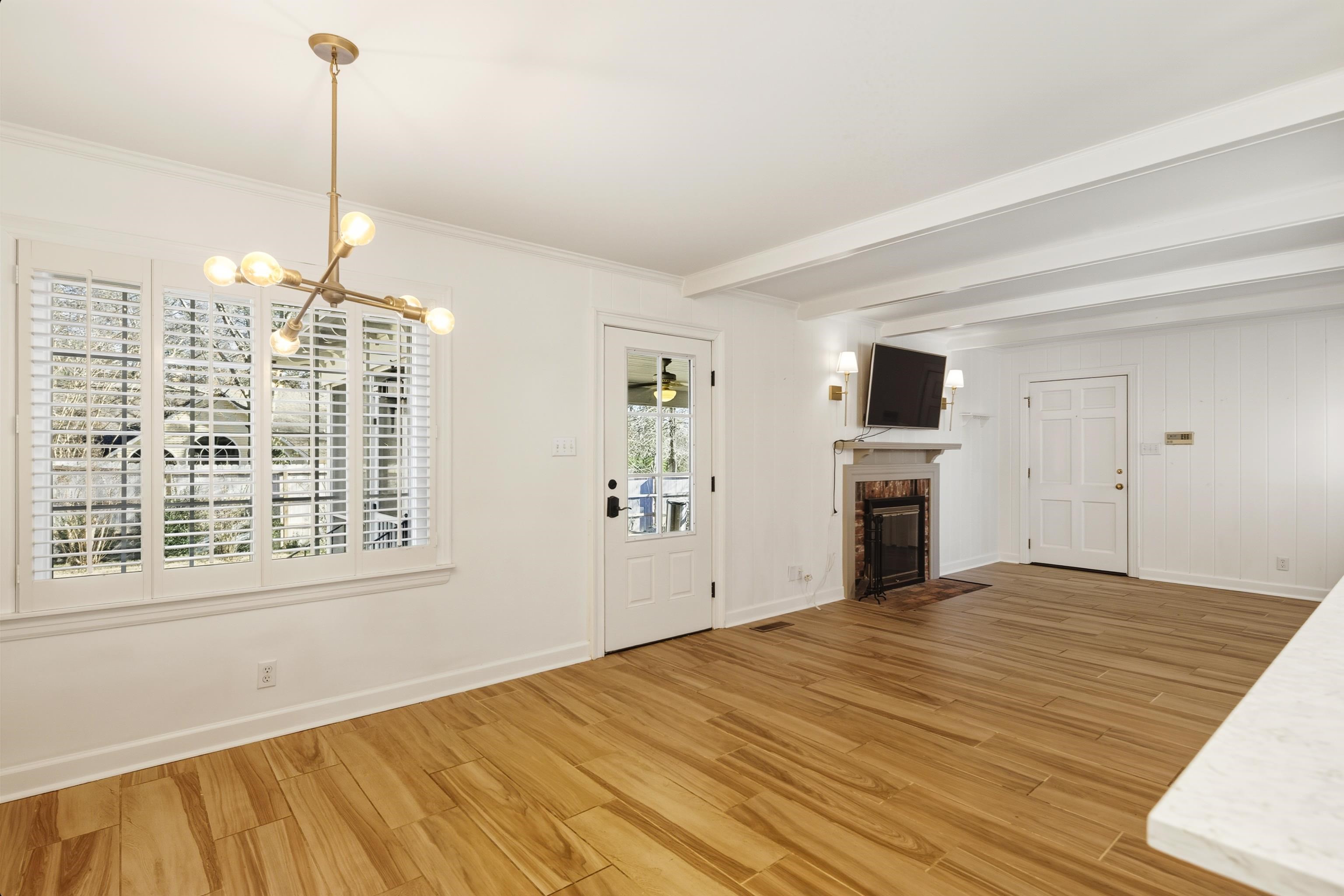 126 Rooks Drive Brownsville, TN 38012 - Photo 13 of 37 a view of empty room with fireplace and windows