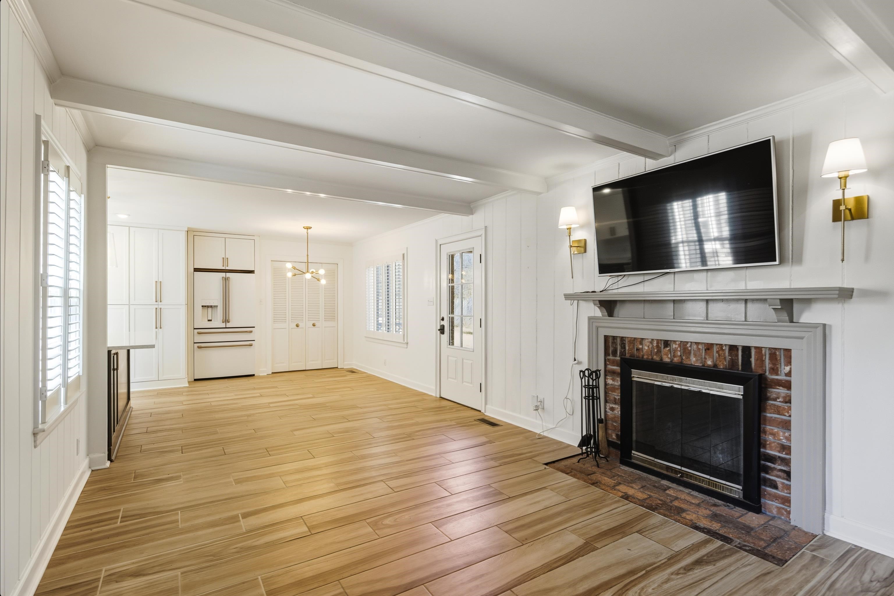 126 Rooks Drive Brownsville, TN 38012 - Photo 15 of 37 a view of a livingroom with a fireplace wooden floor and staircase