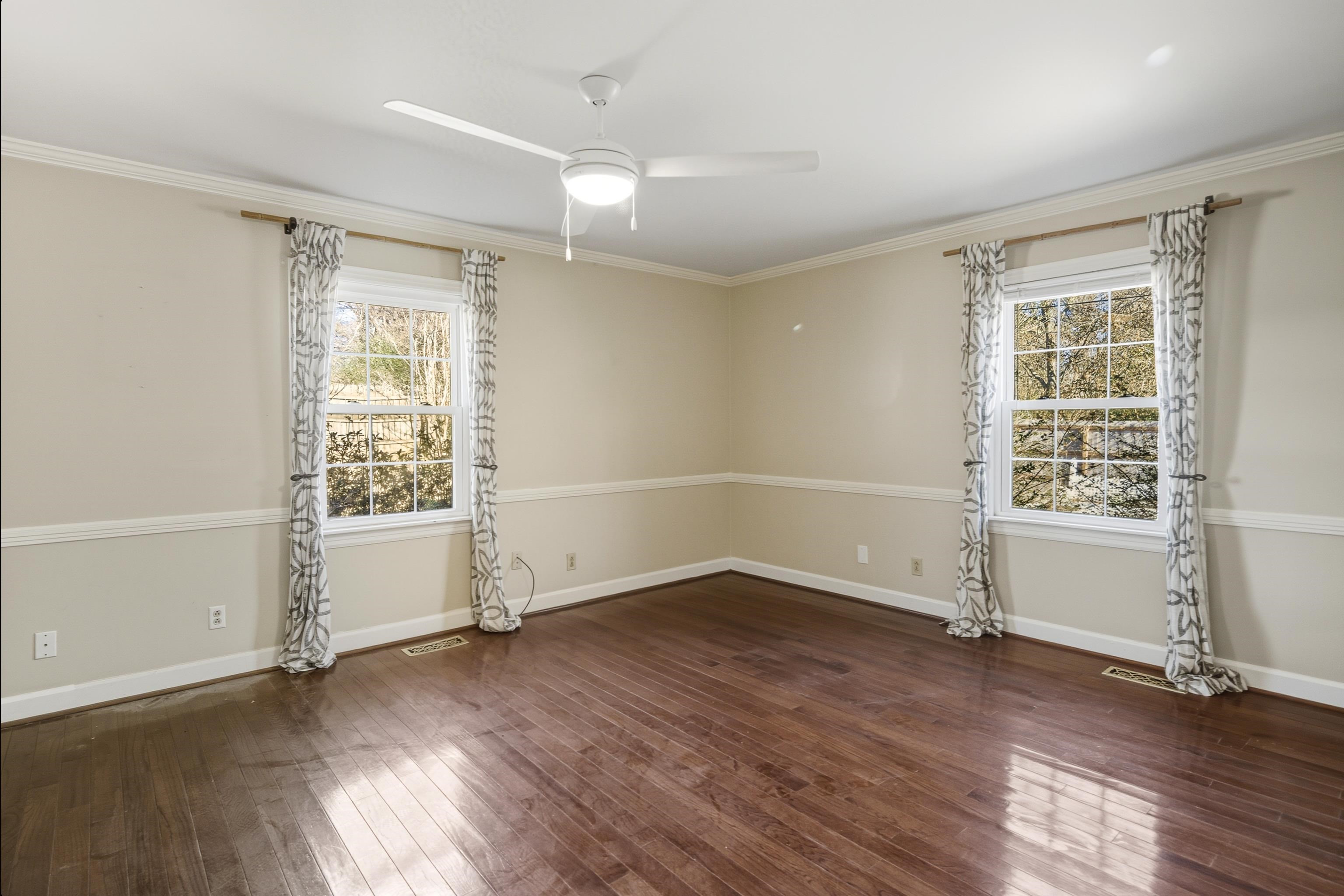 126 Rooks Drive Brownsville, TN 38012 - Photo 17 of 37 an empty room with wooden floor and windows