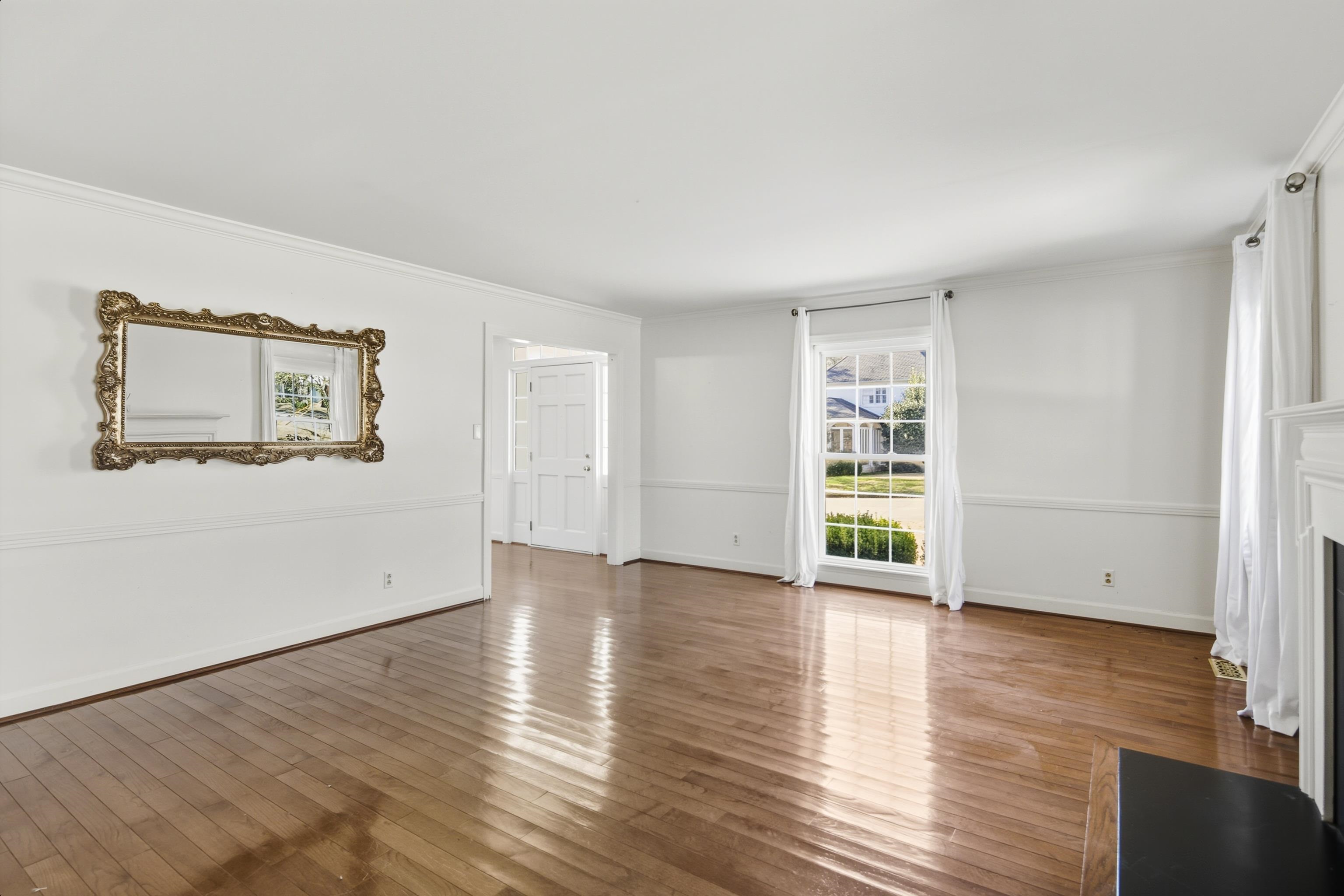 126 Rooks Drive Brownsville, TN 38012 - Photo 7 of 37 a view of an empty room with wooden floor and a window