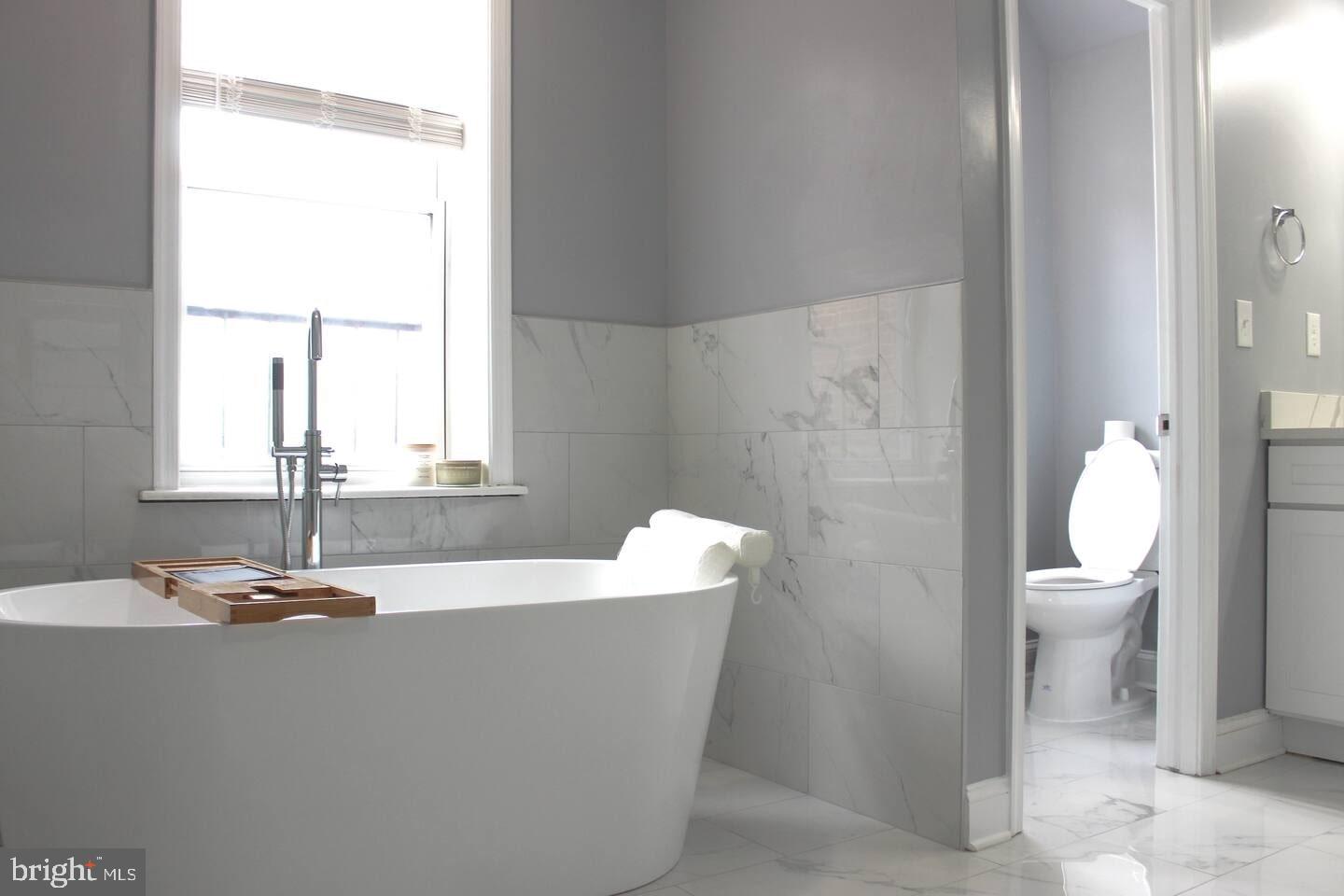 5 East 27th Street Baltimore, MD 21218 - Photo 12 of 34 a bathroom with a sink a toilet and a mirror