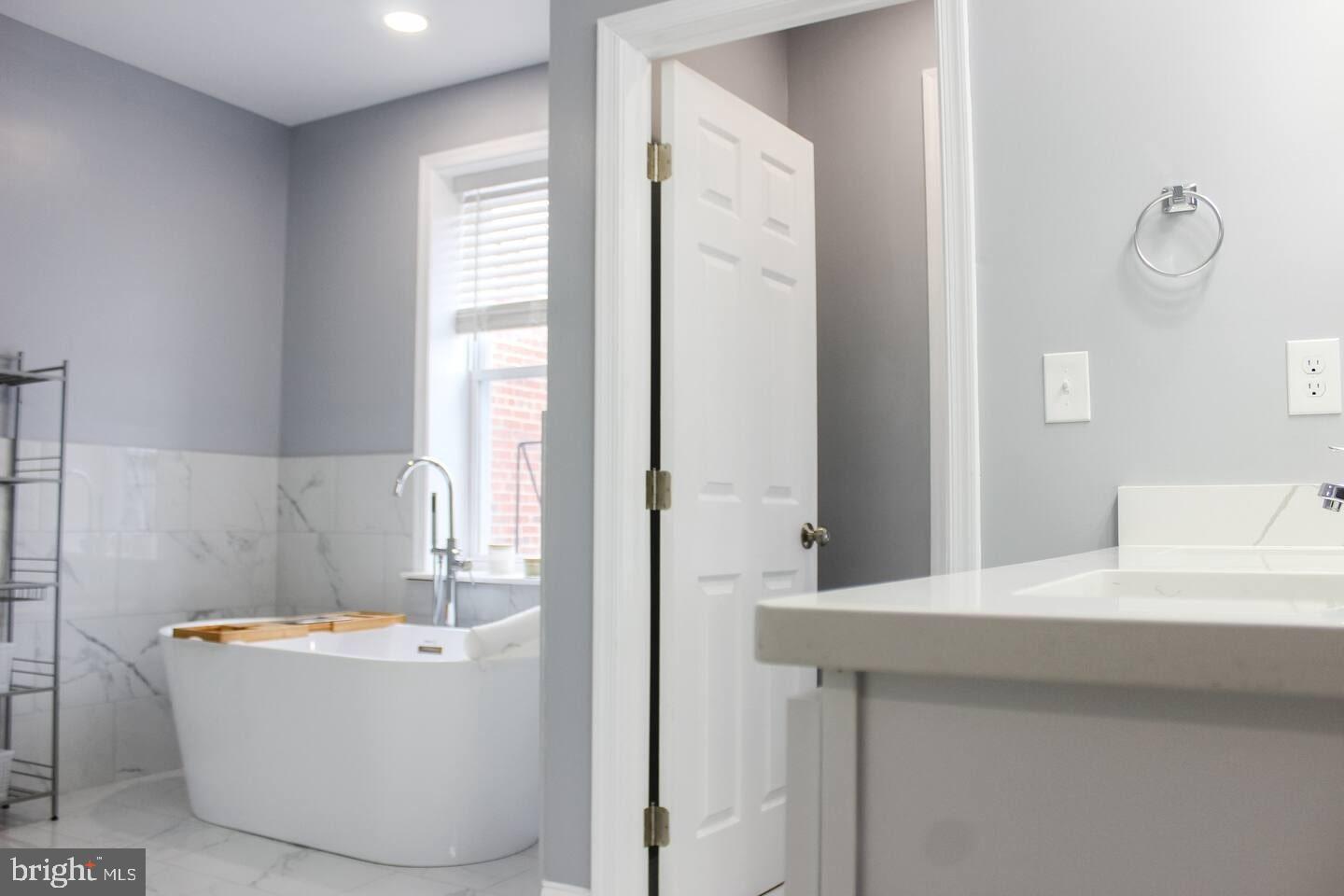 5 East 27th Street Baltimore, MD 21218 - Photo 13 of 34 a bathroom with a bathtub and sink