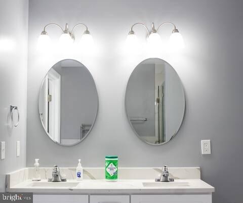 5 East 27th Street Baltimore, MD 21218 - Photo 15 of 34 a bathroom with a sink and a mirror