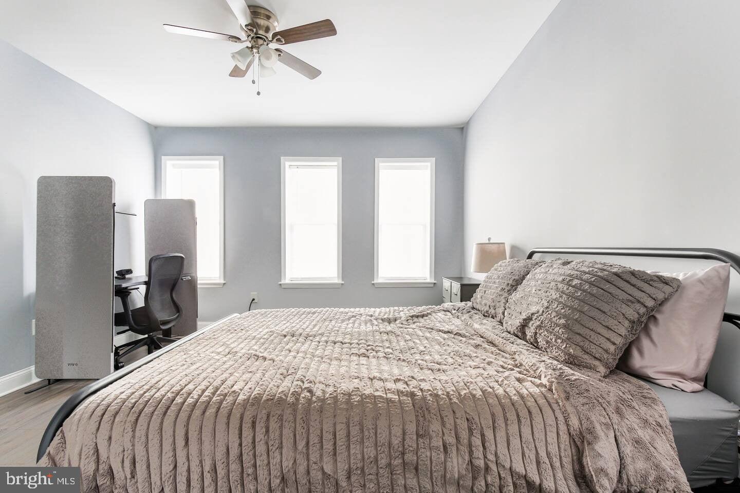 5 East 27th Street Baltimore, MD 21218 - Photo 20 of 34 a bedroom with a bed and a chandelier