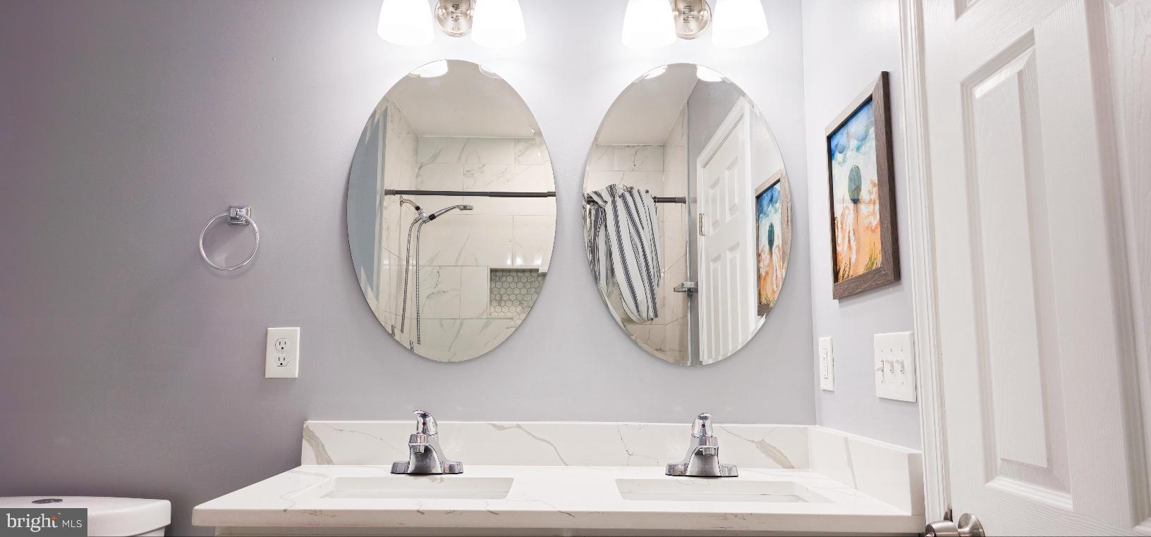 5 East 27th Street Baltimore, MD 21218 - Photo 23 of 34 a bathroom with a sink mirror and vanity