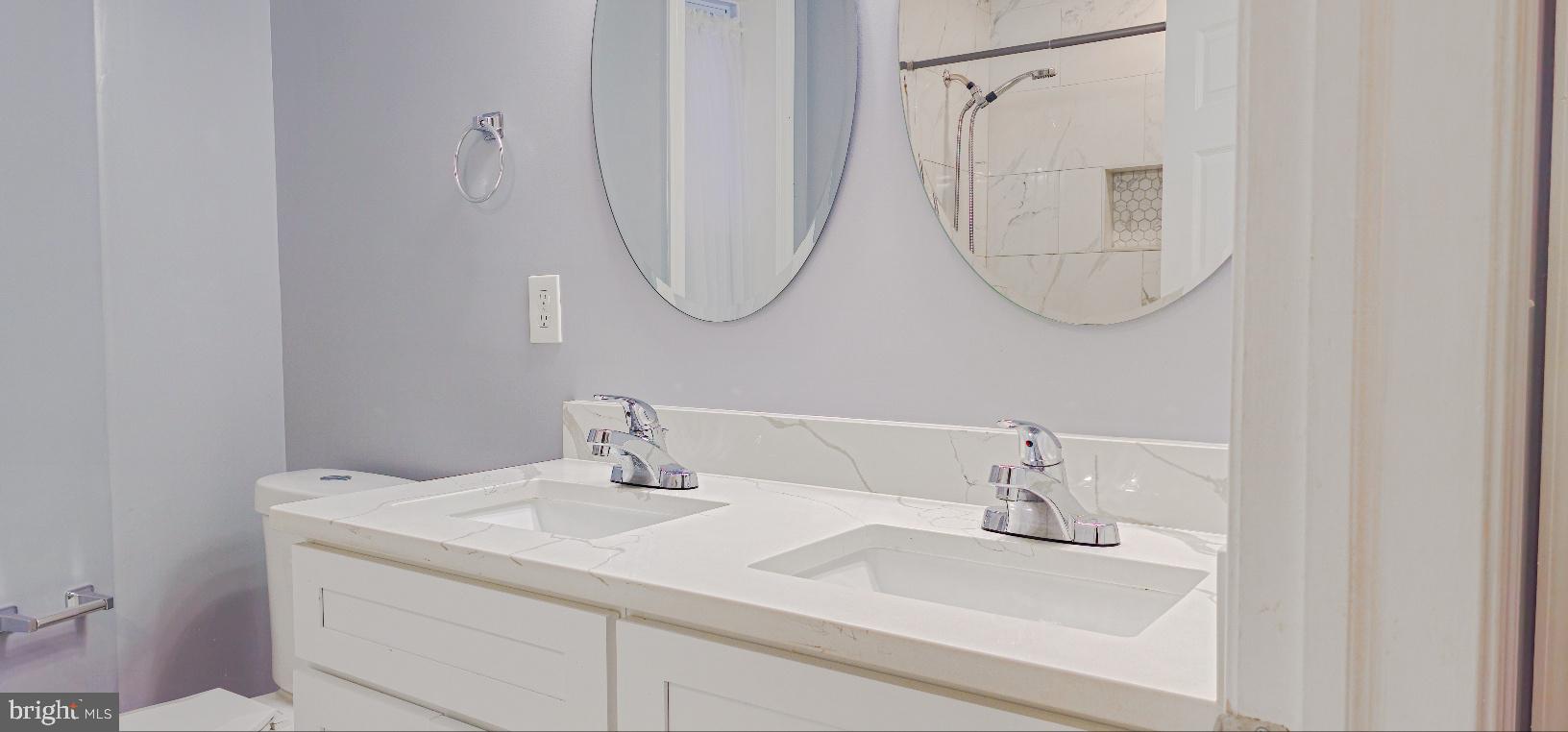 5 East 27th Street Baltimore, MD 21218 - Photo 24 of 34 a bathroom with a sink and a mirror