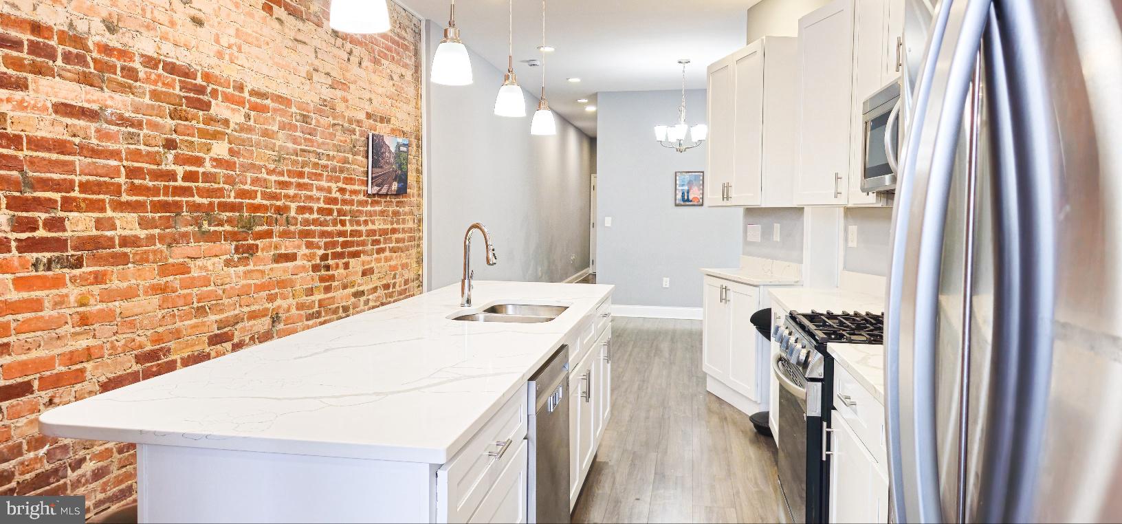 5 East 27th Street Baltimore, MD 21218 - Photo 3 of 34 a bathroom with a sink a mirror and a shower