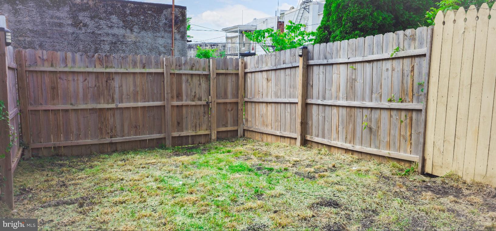 5 East 27th Street Baltimore, MD 21218 - Photo 31 of 34 a view of a backyard with a wooden fence