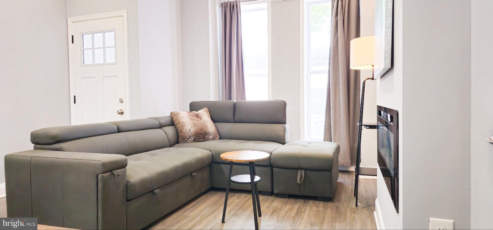 5 East 27th Street Baltimore, MD 21218 - Photo 5 of 34 a living room with furniture and a window