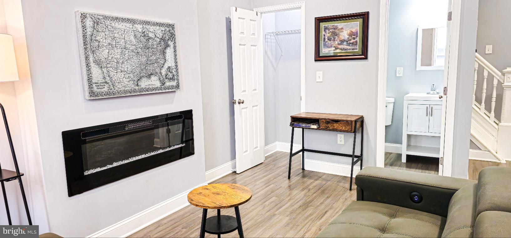 5 East 27th Street Baltimore, MD 21218 - Photo 6 of 34 a living room with furniture and a fireplace