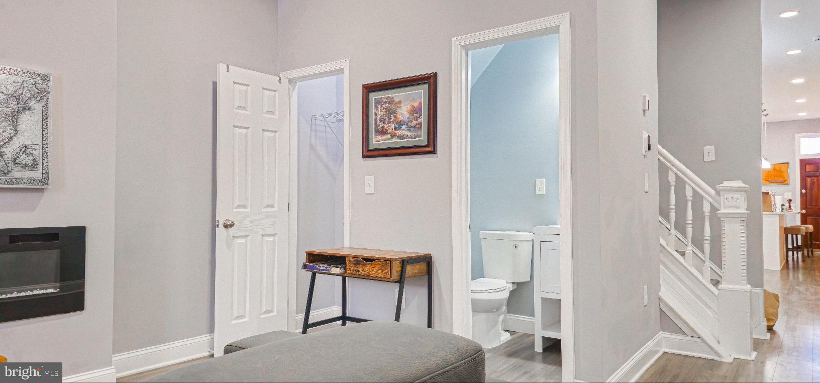 5 East 27th Street Baltimore, MD 21218 - Photo 7 of 34 a living room with furniture a rug and a painting on the wall