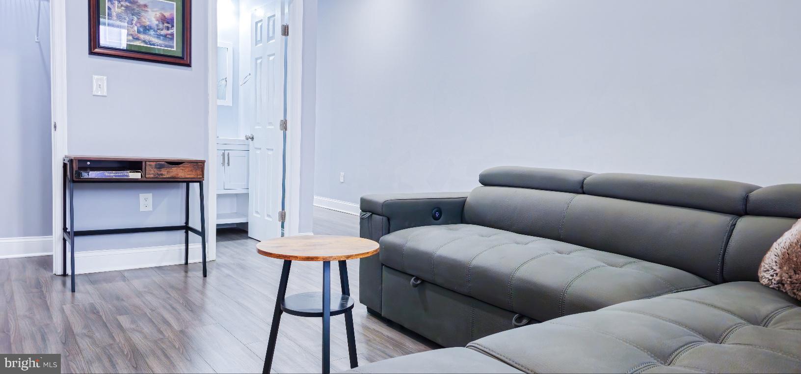 5 East 27th Street Baltimore, MD 21218 - Photo 8 of 34 a living room with furniture and a wooden floor
