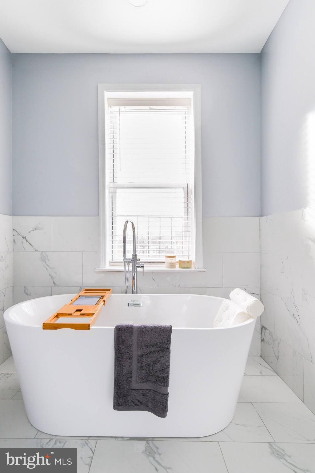 5 East 27th Street Baltimore, MD 21218 - Photo 10 of 34 a white bath tub sitting in a bathroom