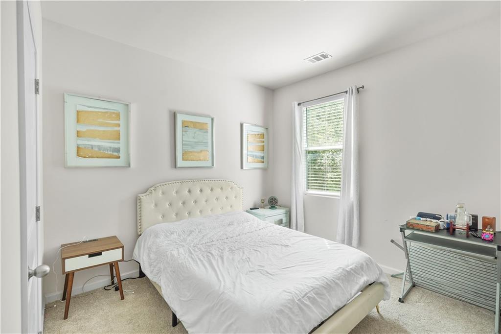 499 Walnut Grv Way Pendergrass, GA 30567 - Photo 13 of 19 a bedroom with a bed and a window