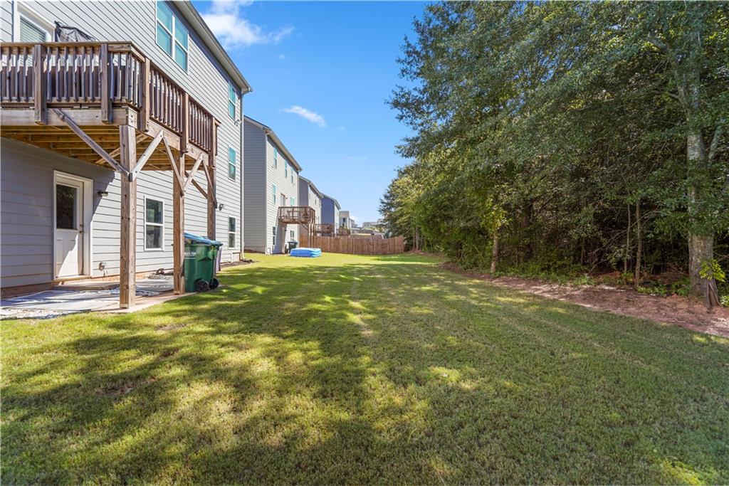 499 Walnut Grv Way Pendergrass, GA 30567 - Photo 18 of 19 a backyard of a house with lots of green space