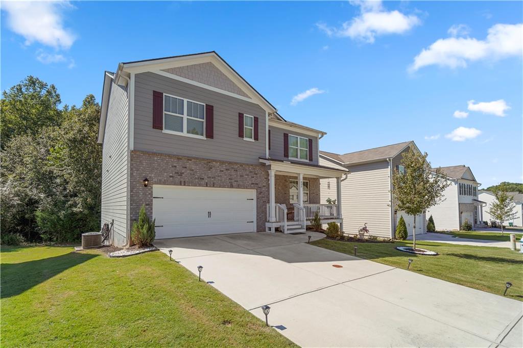 499 Walnut Grv Way Pendergrass, GA 30567 - Photo 19 of 19 a front view of a house with a yard