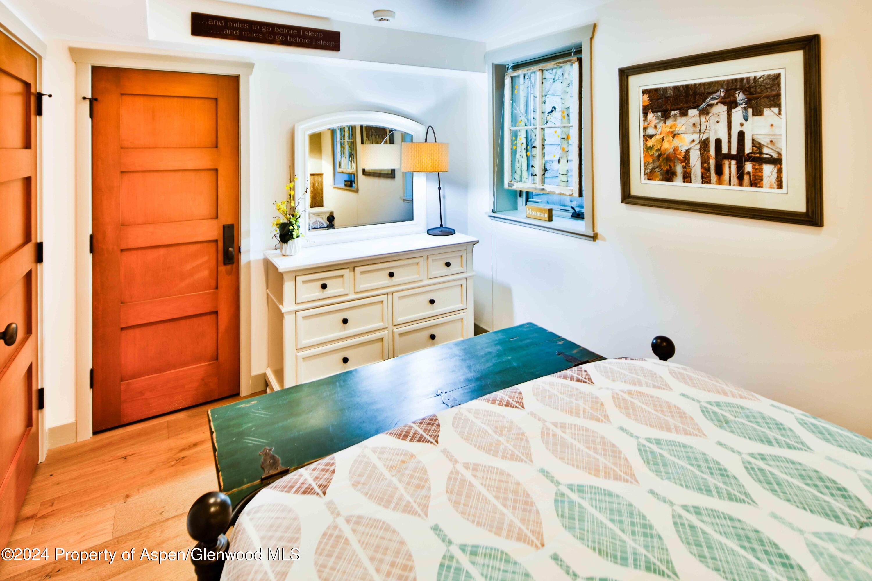 389 Elk Mountain Drive Redstone, CO 81623 - Photo 57 of 64 a bedroom with a bed and a dresser next to a window