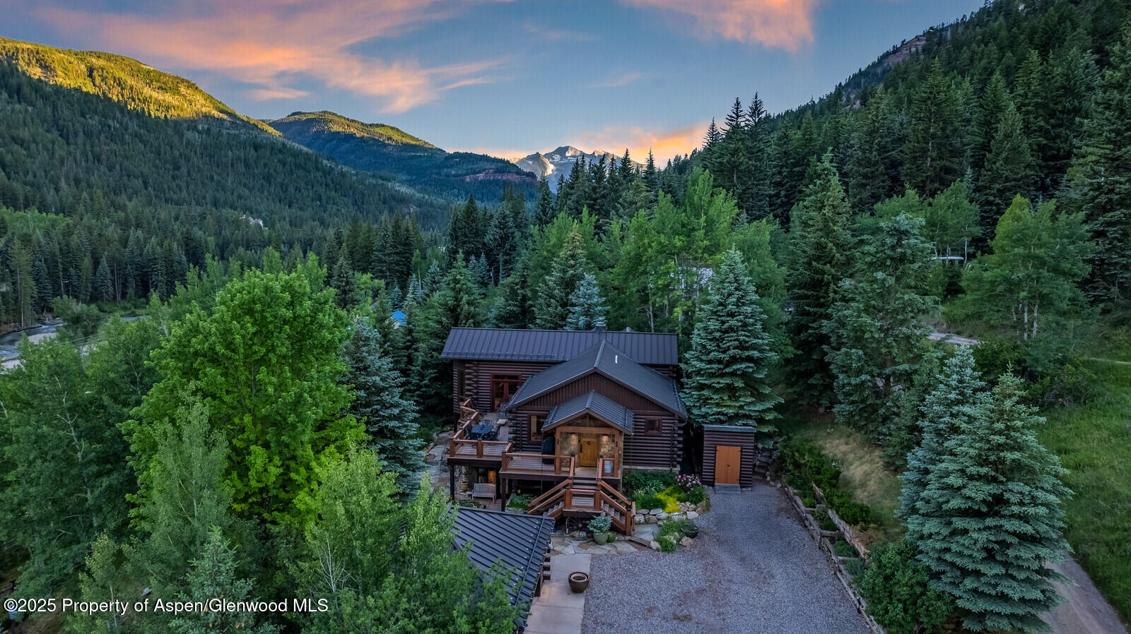 389 Elk Mountain Drive Redstone, CO 81623 - Photo 9 of 64 a view of a big house with a big yard and large trees
