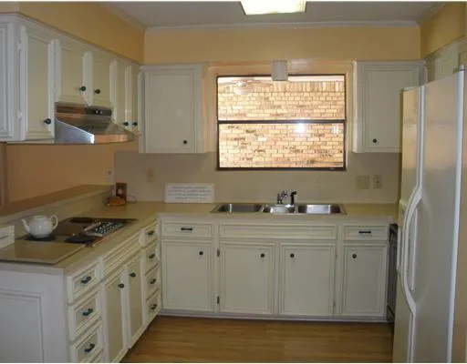 a kitchen with stainless steel appliances a stove a sink and a refrigerator