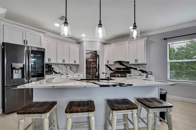 a kitchen with stainless steel appliances granite countertop a stove and a refrigerator