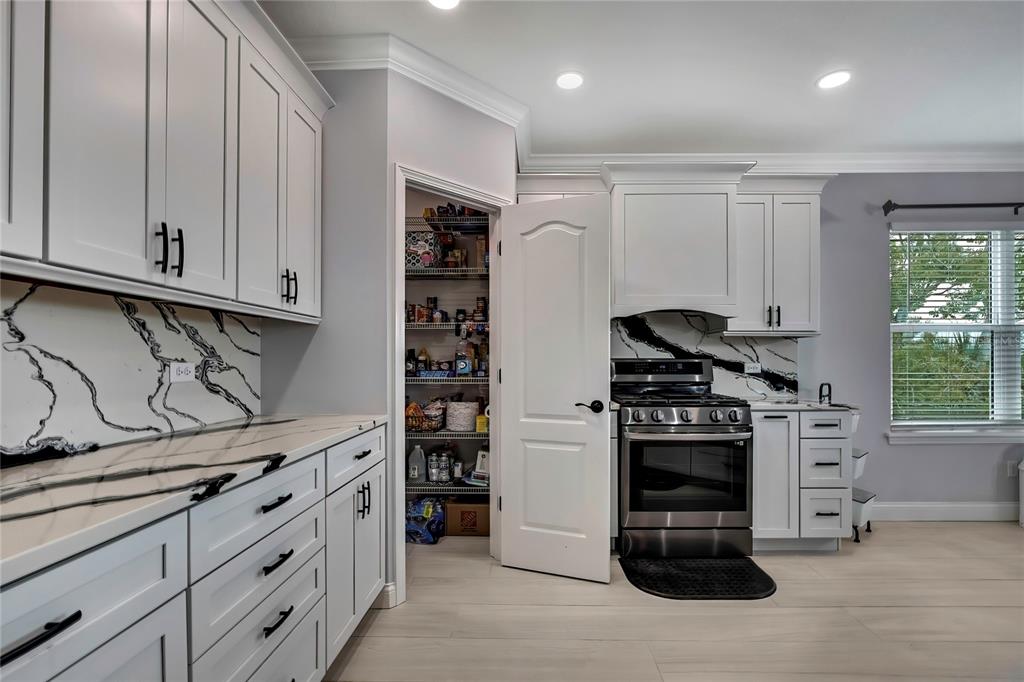 3276 Sea Grape Drive Hernando Beach, FL 34607 - Photo 12 of 55 a kitchen with stainless steel appliances granite countertop a stove and a refrigerator