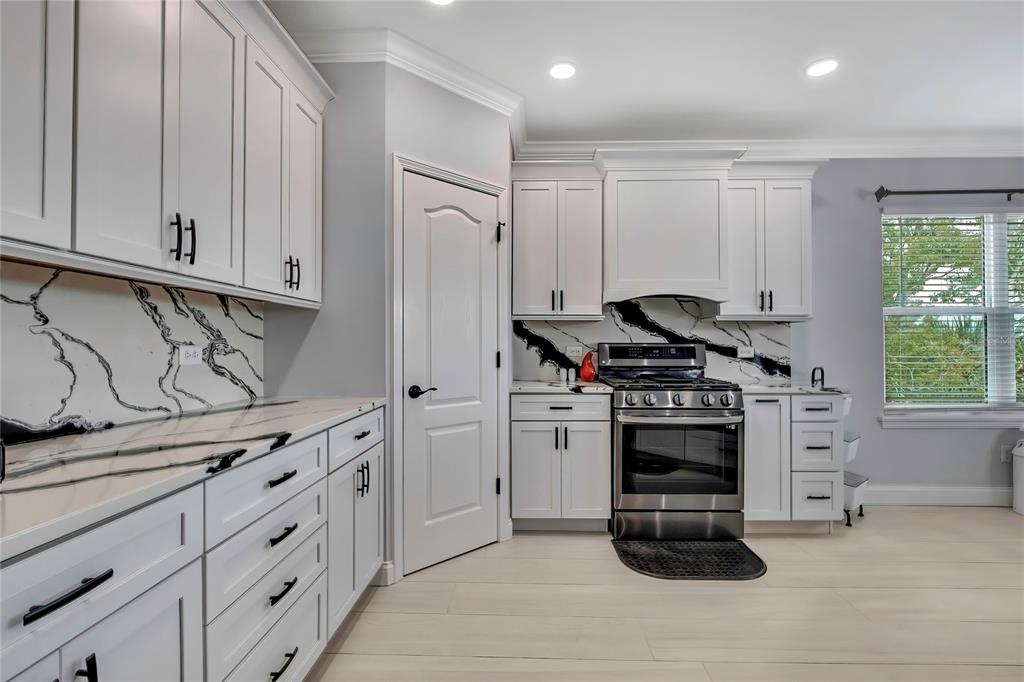 3276 Sea Grape Drive Hernando Beach, FL 34607 - Photo 14 of 55 a kitchen with stainless steel appliances granite countertop a stove and a refrigerator